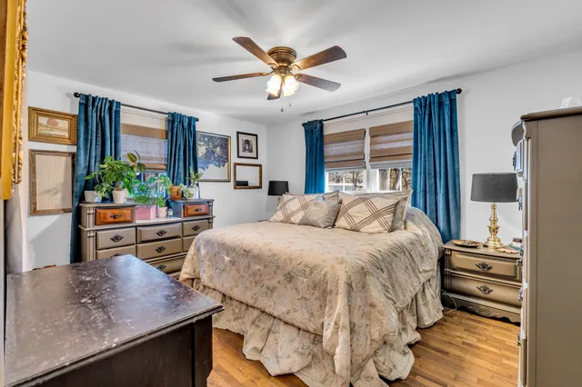 a bed sitting in a bedroom next to a window