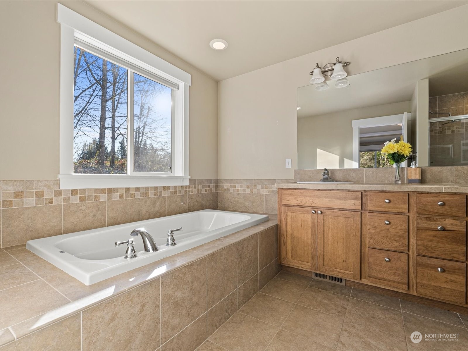 4831 Northeast 13th Place Renton, WA 98059 - Photo 17 of 24 a spacious bathroom with a tub sink and mirror