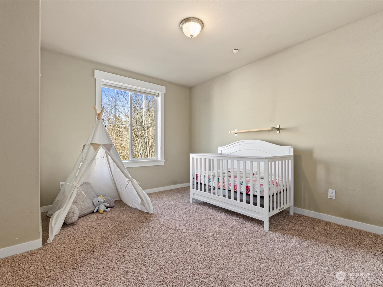 4831 Northeast 13th Place Renton, WA 98059 - Photo 20 of 24 a room with a baby bed a couch and a window