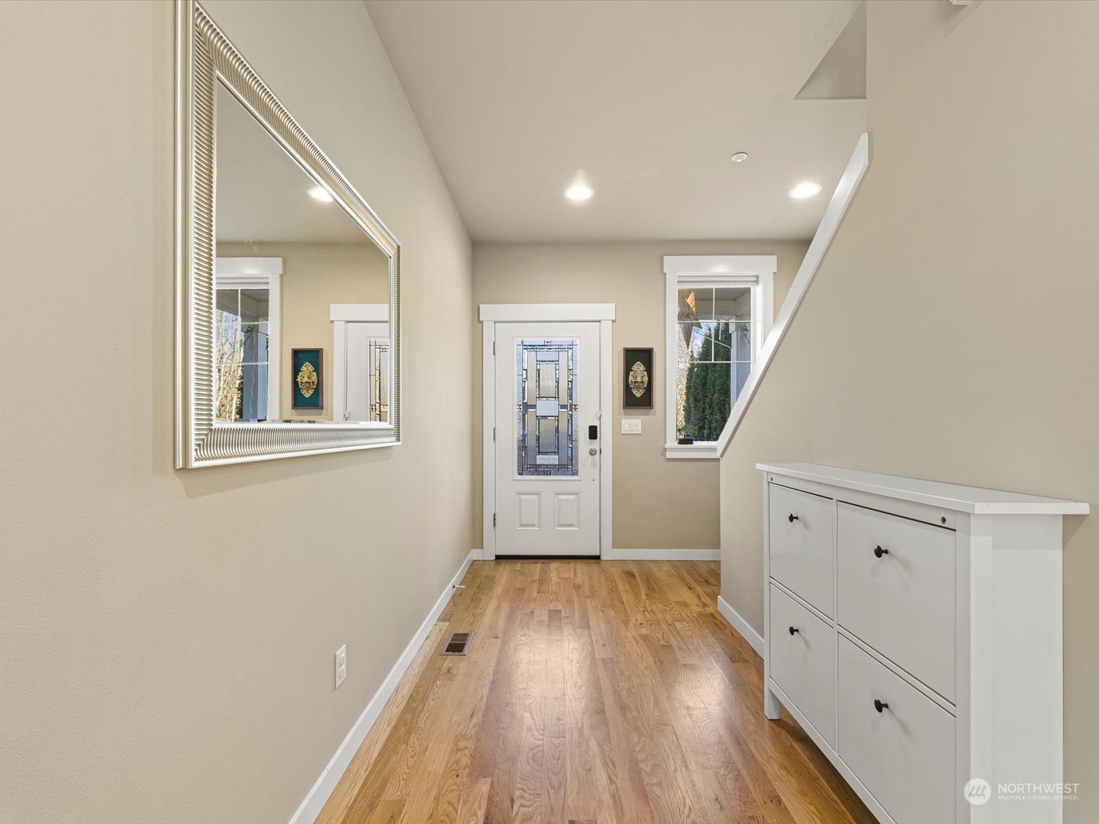 4831 Northeast 13th Place Renton, WA 98059 - Photo 3 of 24 a view of a hallway with wooden floor