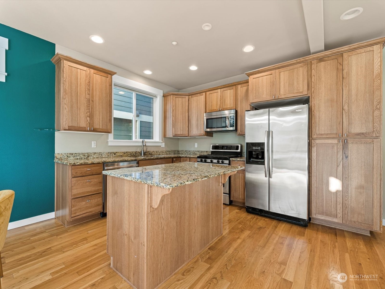 4831 Northeast 13th Place Renton, WA 98059 - Photo 5 of 24 a kitchen with stainless steel appliances granite countertop a refrigerator a stove top oven a sink and dishwasher with wooden floor