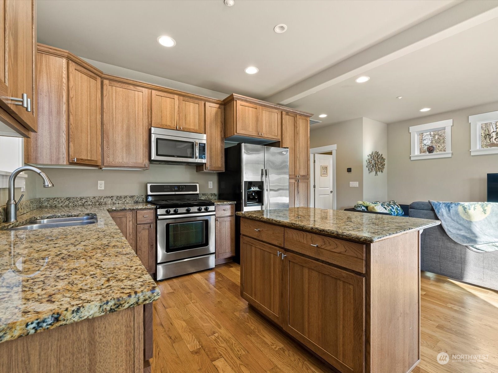 4831 Northeast 13th Place Renton, WA 98059 - Photo 7 of 24 a kitchen with stainless steel appliances granite countertop a stove a sink and a microwave