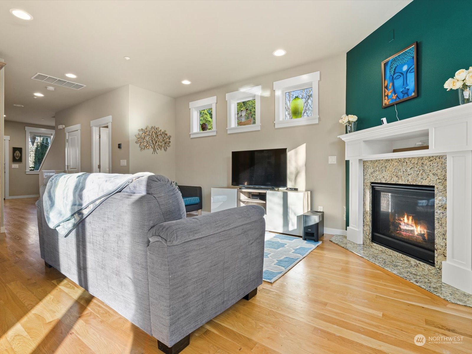 4831 Northeast 13th Place Renton, WA 98059 - Photo 9 of 24 a living room with furniture a flat screen tv and a fireplace