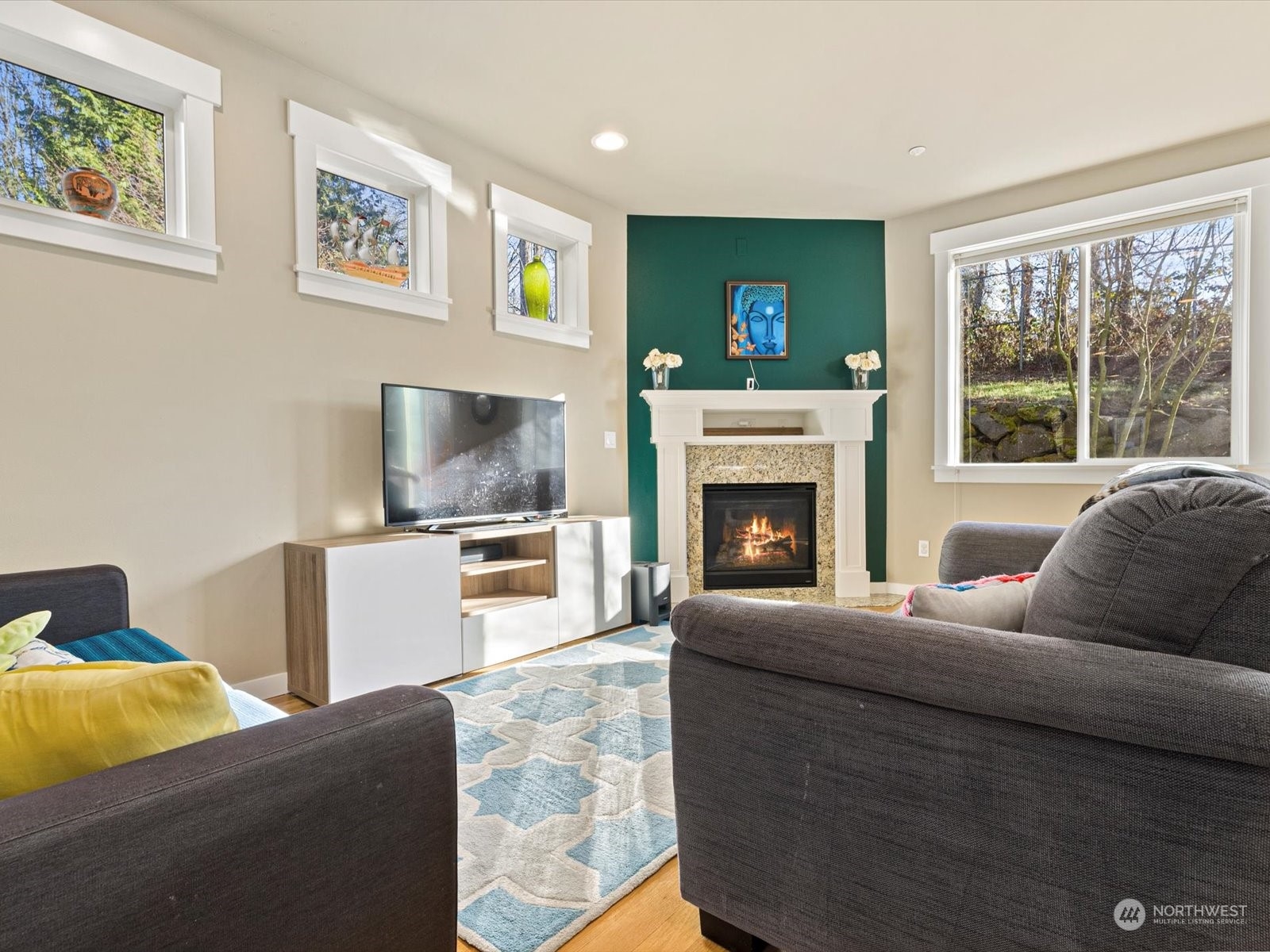 4831 Northeast 13th Place Renton, WA 98059 - Photo 10 of 24 a living room with furniture a flat screen tv and a fireplace