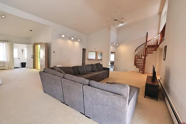 a living room with furniture and a dining table