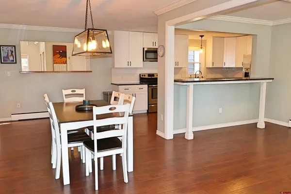 a view of a kitchen with workspace and wooden floor