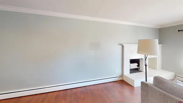 a view of empty room with wooden floor and cabinet