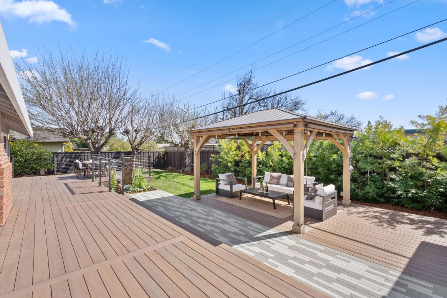1999 Scott Lane Los Altos, CA 94024 - Photo 37 of 44 a view of a patio with table and chairs potted plants with wooden floor and fence