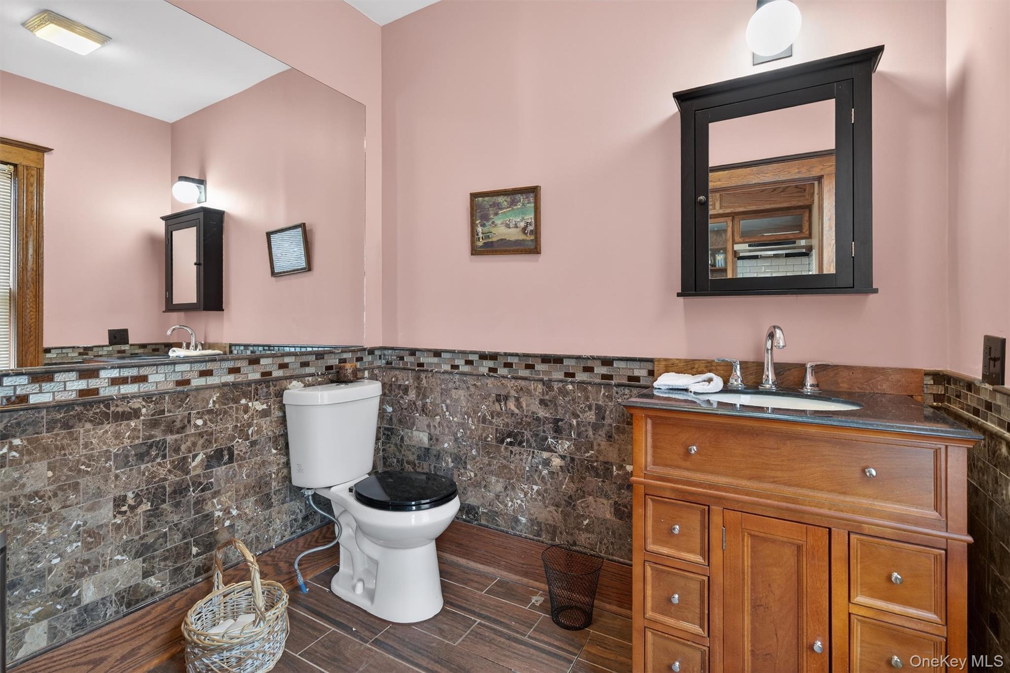 48 Kirks Road Narrowsburg, NY 12764 - Photo 37 of 50 a bathroom with a toilet a sink and mirror