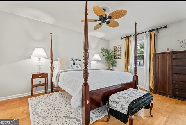a bedroom with a bed a flat screen tv and a chandelier