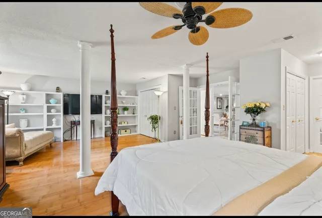 a bedroom with furniture and a flat screen tv