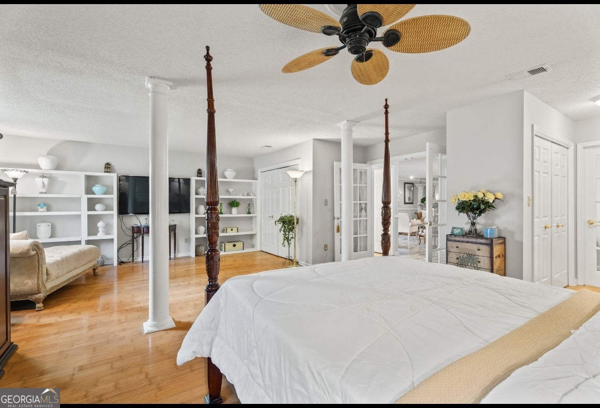 81 Hampshire Court Avondale Estates, GA 30002 - Photo 14 of 50 a bedroom with a bed chandelier and view of living room