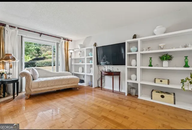 a view of a hallway with wooden floor and entryway