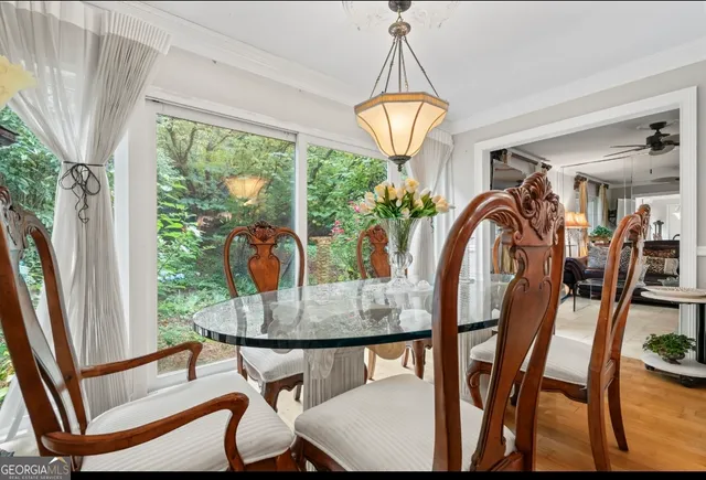 a view of a dining room with furniture wooden floor and chandelier