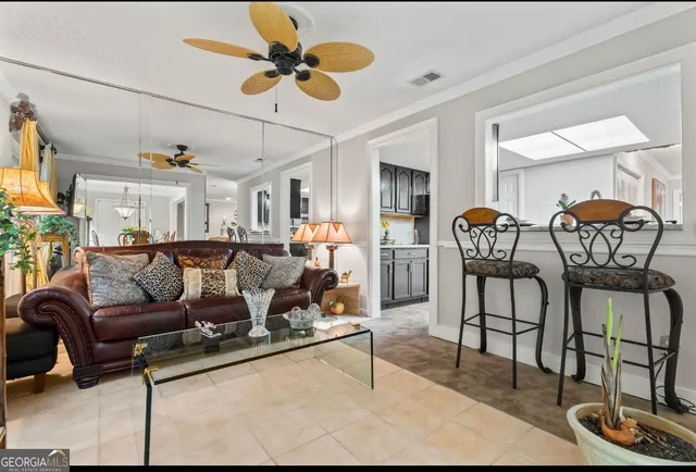 a living room with furniture and a potted plant