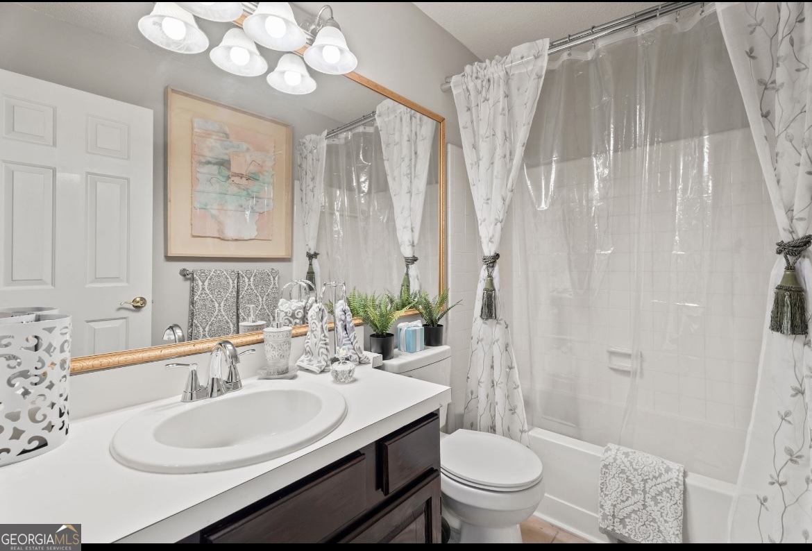 81 Hampshire Court Avondale Estates, GA 30002 - Photo 23 of 50 a bathroom with a sink a toilet and a mirror