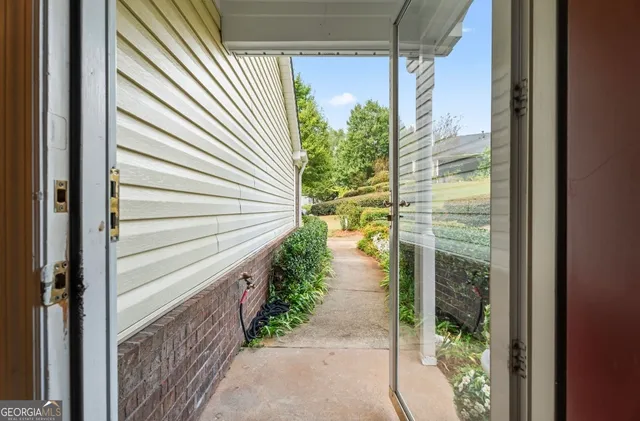a backyard of a house with table and chairs