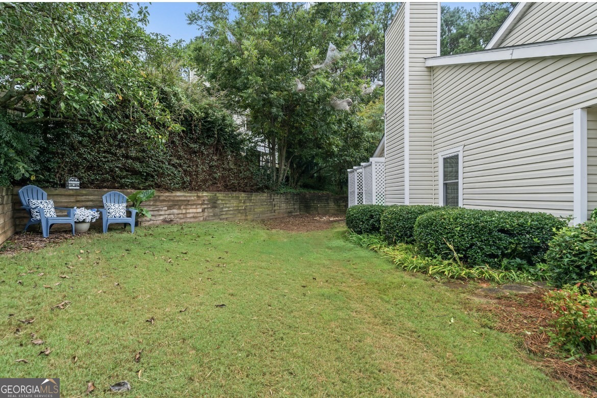 81 Hampshire Court Avondale Estates, GA 30002 - Photo 27 of 50 a backyard of a house with table and chairs