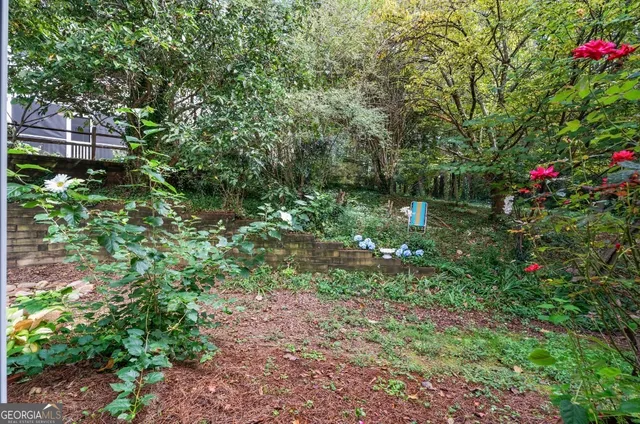 a view of a swimming pool with a yard and sitting area