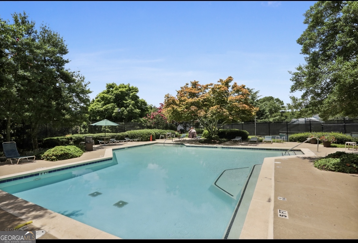 81 Hampshire Court Avondale Estates, GA 30002 - Photo 32 of 50 a view of a swimming pool with a yard and sitting area