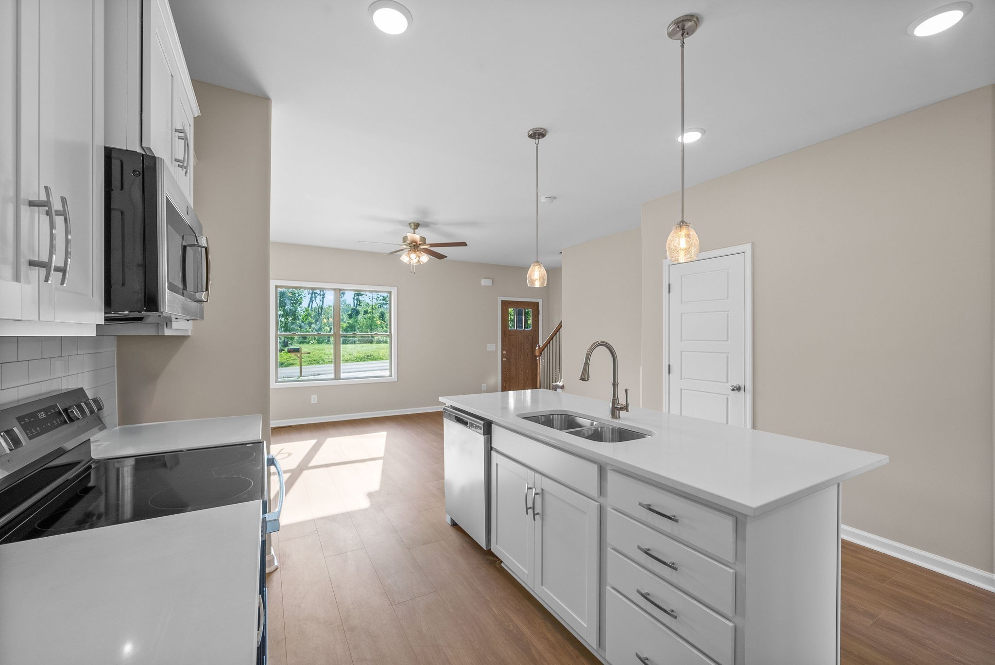 a kitchen with a sink stove and microwave