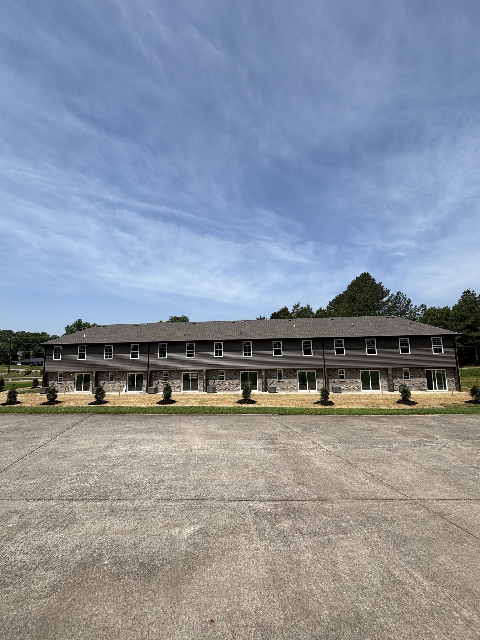 106 Colson Road Dover, TN 37058 - Photo 22 of 26 a view of a large building with a big yard and large trees