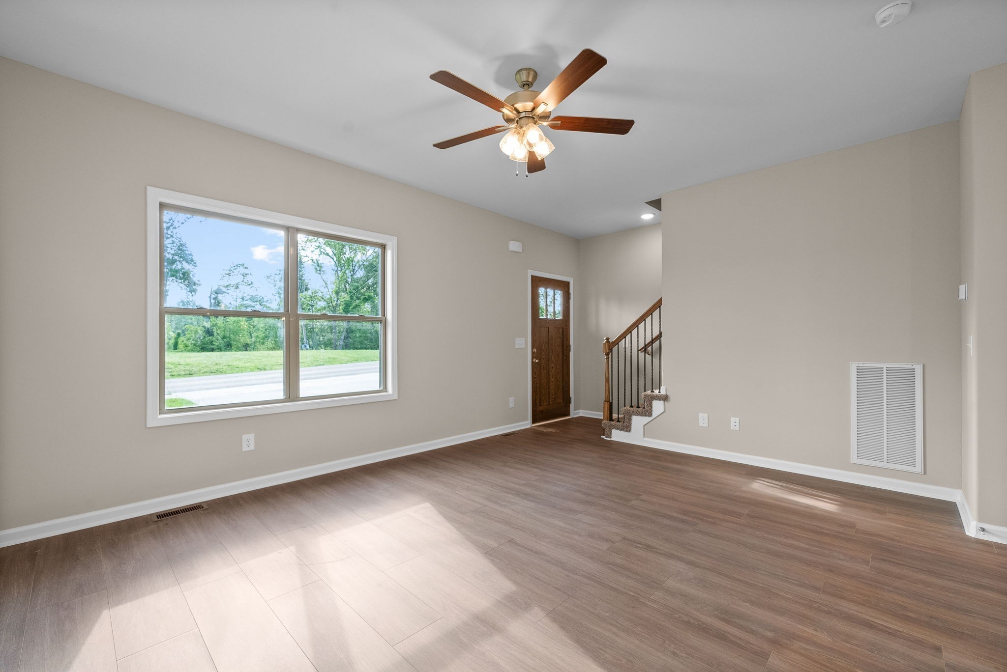 106 Colson Road Dover, TN 37058 - Photo 5 of 26 a view of an empty room with wooden floor and a window