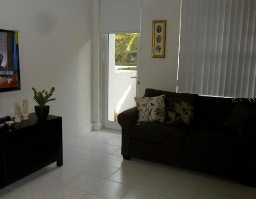 100 Lincoln Road, Unit 332 Miami Beach, FL 33139 - Photo 10 of 14 a living room with furniture and a gate