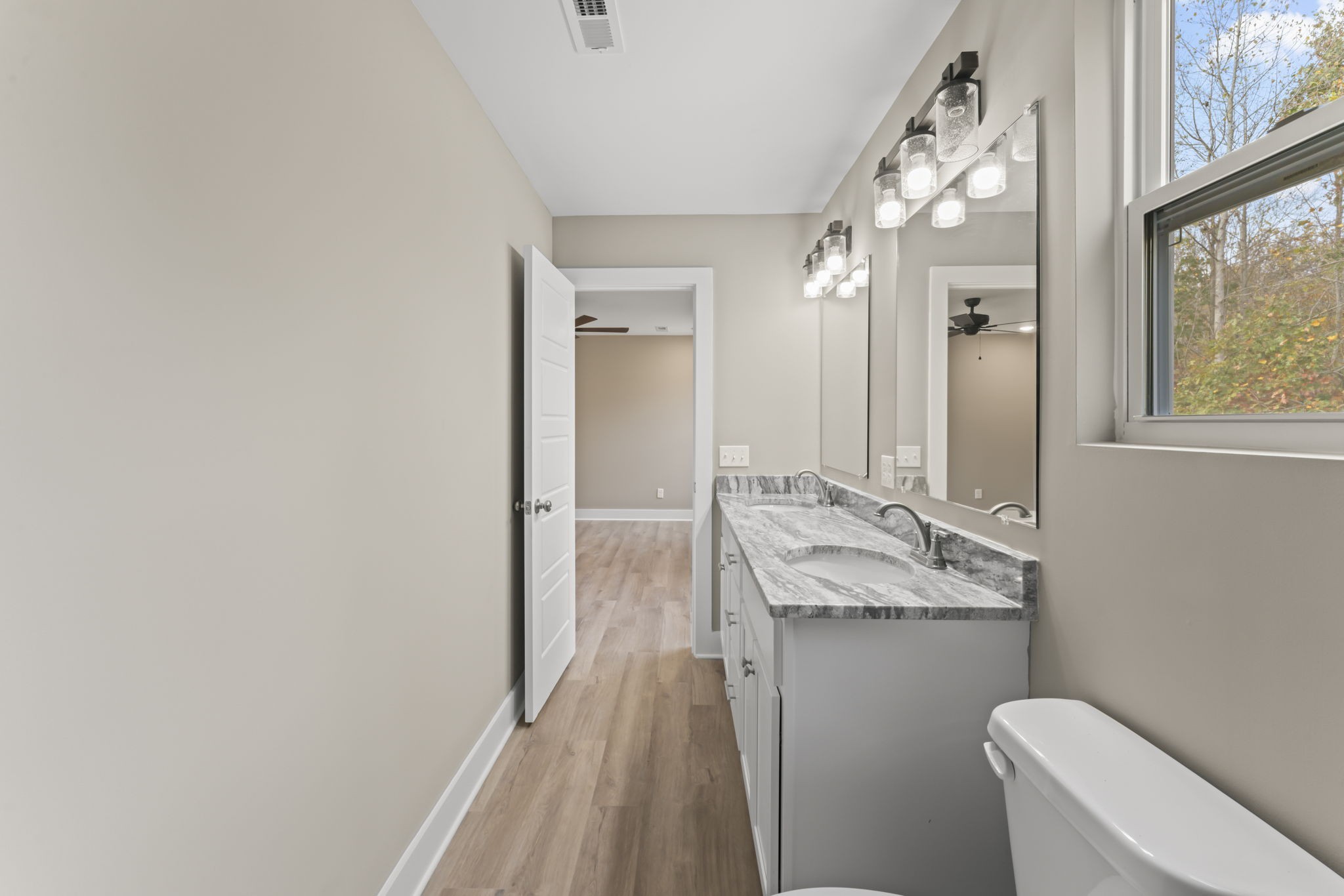 4357 Surji Circle Centerville, TN 37033 - Photo 19 of 25 a bathroom with a granite countertop sink vanity mirror and toilet