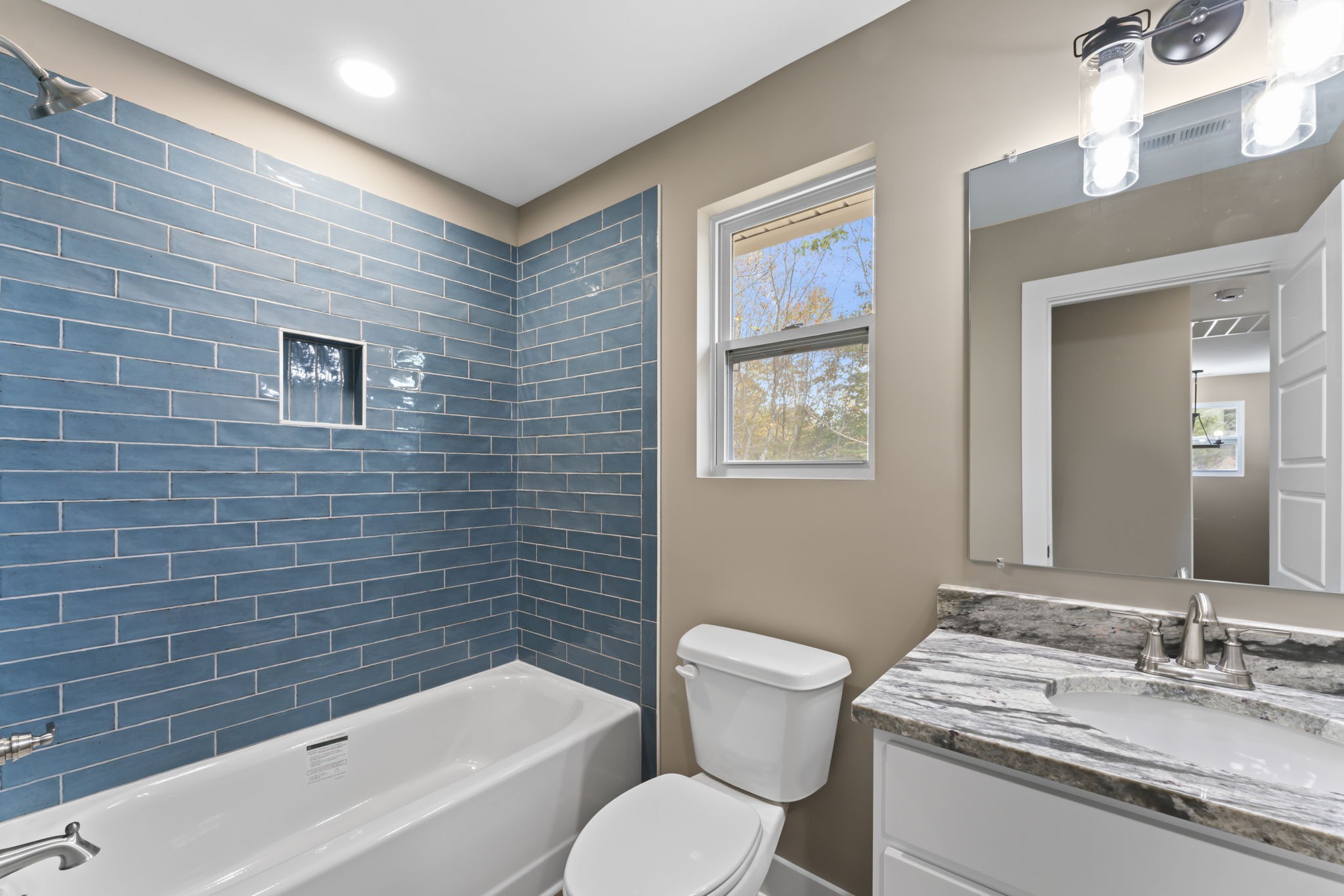 4357 Surji Circle Centerville, TN 37033 - Photo 21 of 25 a bathroom with a granite countertop toilet a sink and bathtub