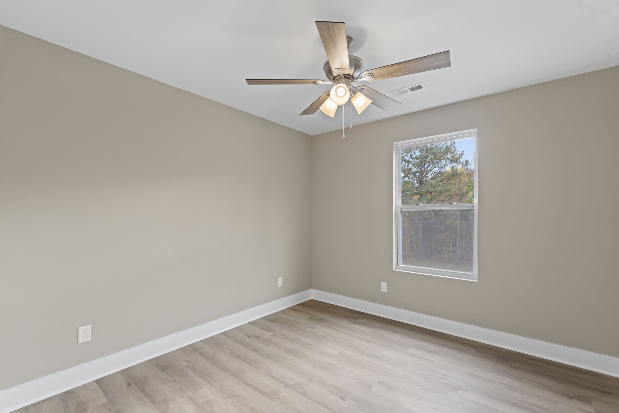 4357 Surji Circle Centerville, TN 37033 - Photo 22 of 25 an empty room with windows and fan