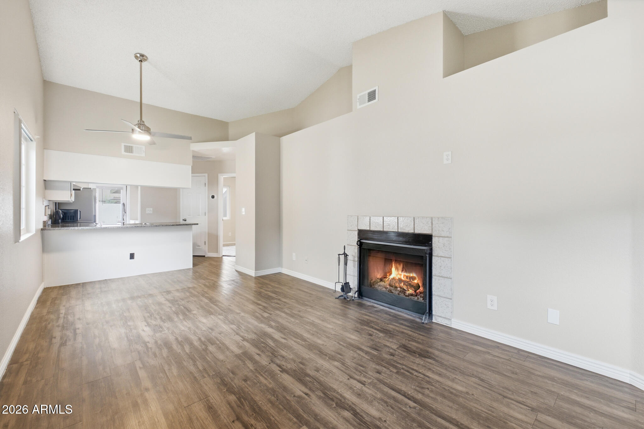 170 East Guadalupe Road, Unit 112 Gilbert, AZ 85234 - Photo 13 of 22 a view of a room with a fireplace and wooden floor