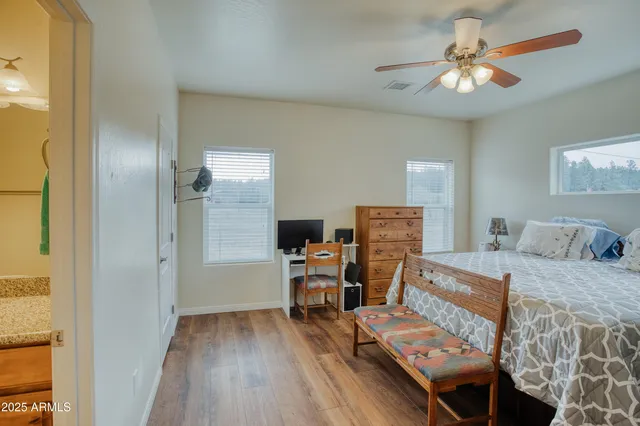 a bathroom with a granite countertop sink a toilet a mirror a bathtub and shower