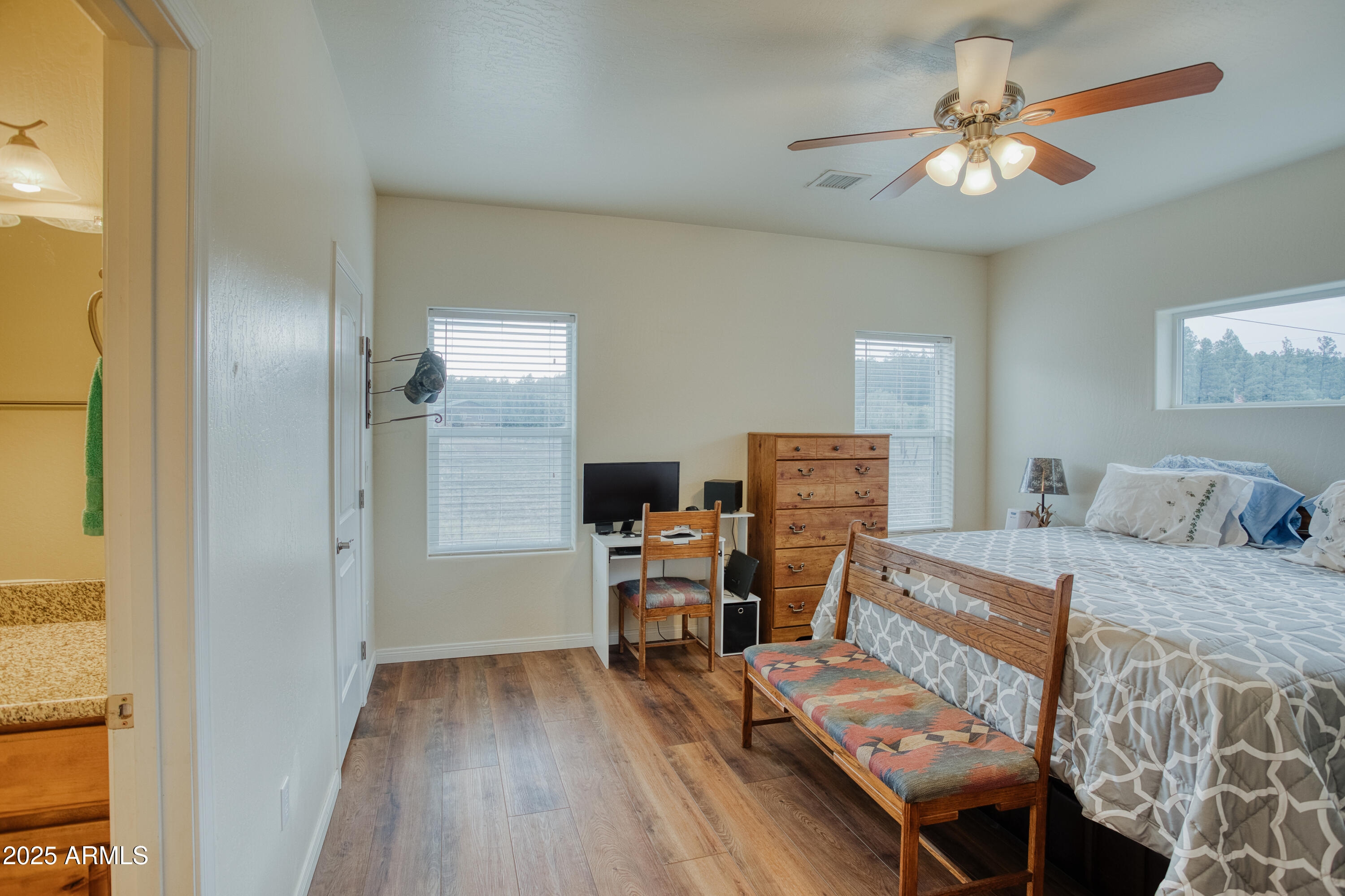 540 Rim Drive Show Low, AZ 85901 - Photo 11 of 35 a bedroom with furniture and a wooden floor