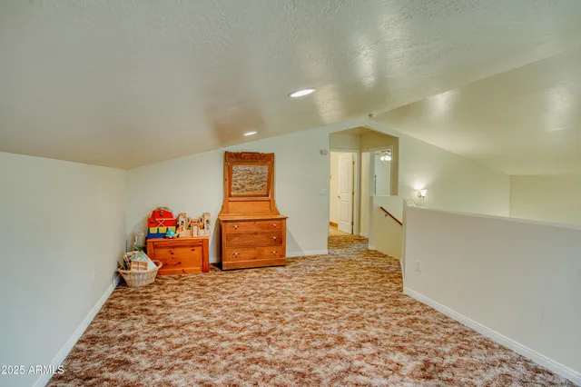 a view of a livingroom with wooden floor and a potted plant