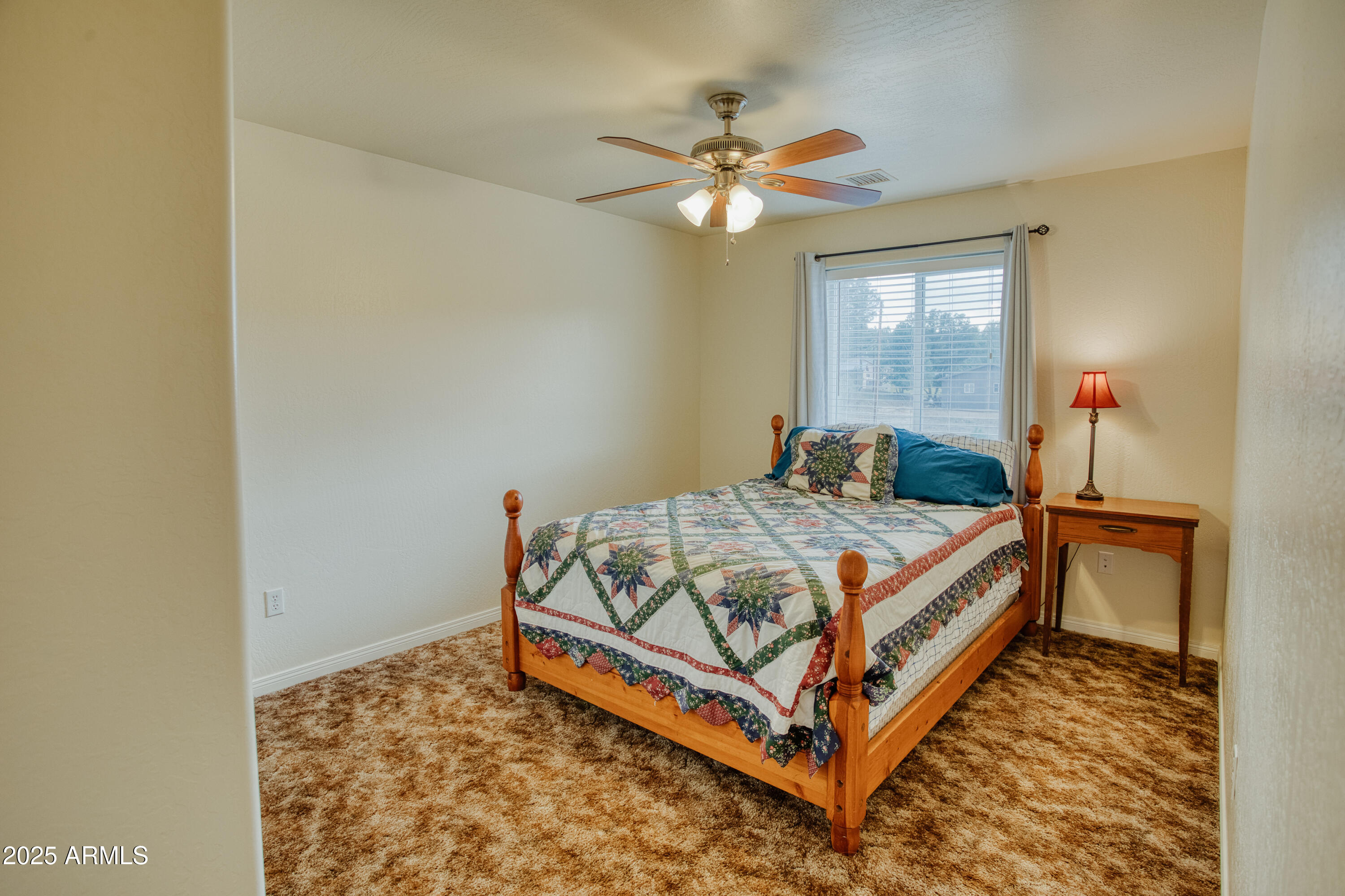 540 Rim Drive Show Low, AZ 85901 - Photo 16 of 35 a bed sitting in a bedroom next to a window