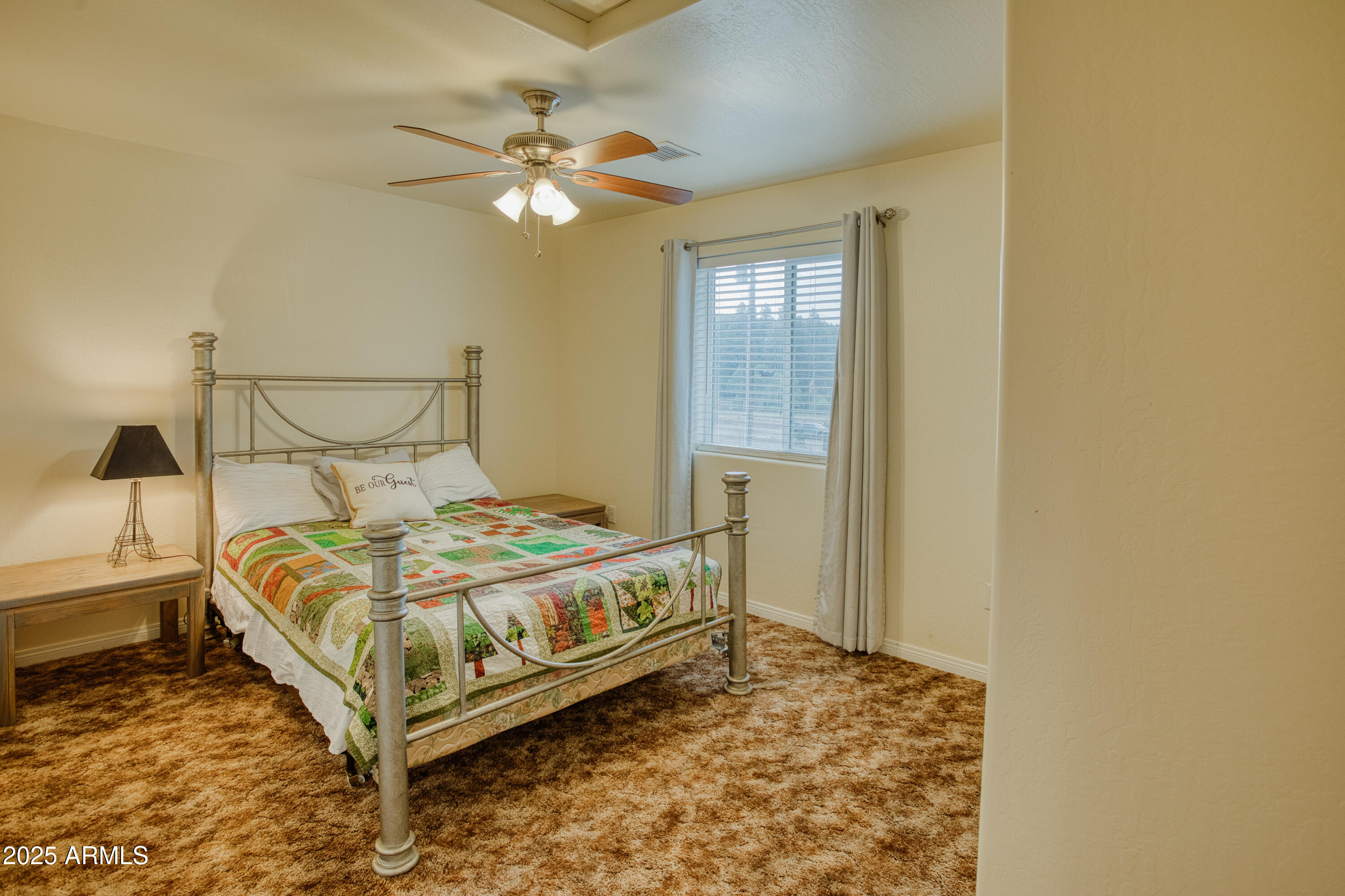 540 Rim Drive Show Low, AZ 85901 - Photo 18 of 35 a bed sitting in a bedroom next to a window