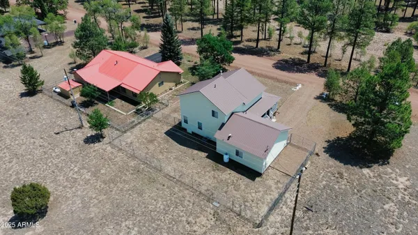 an aerial view of a house with a yard