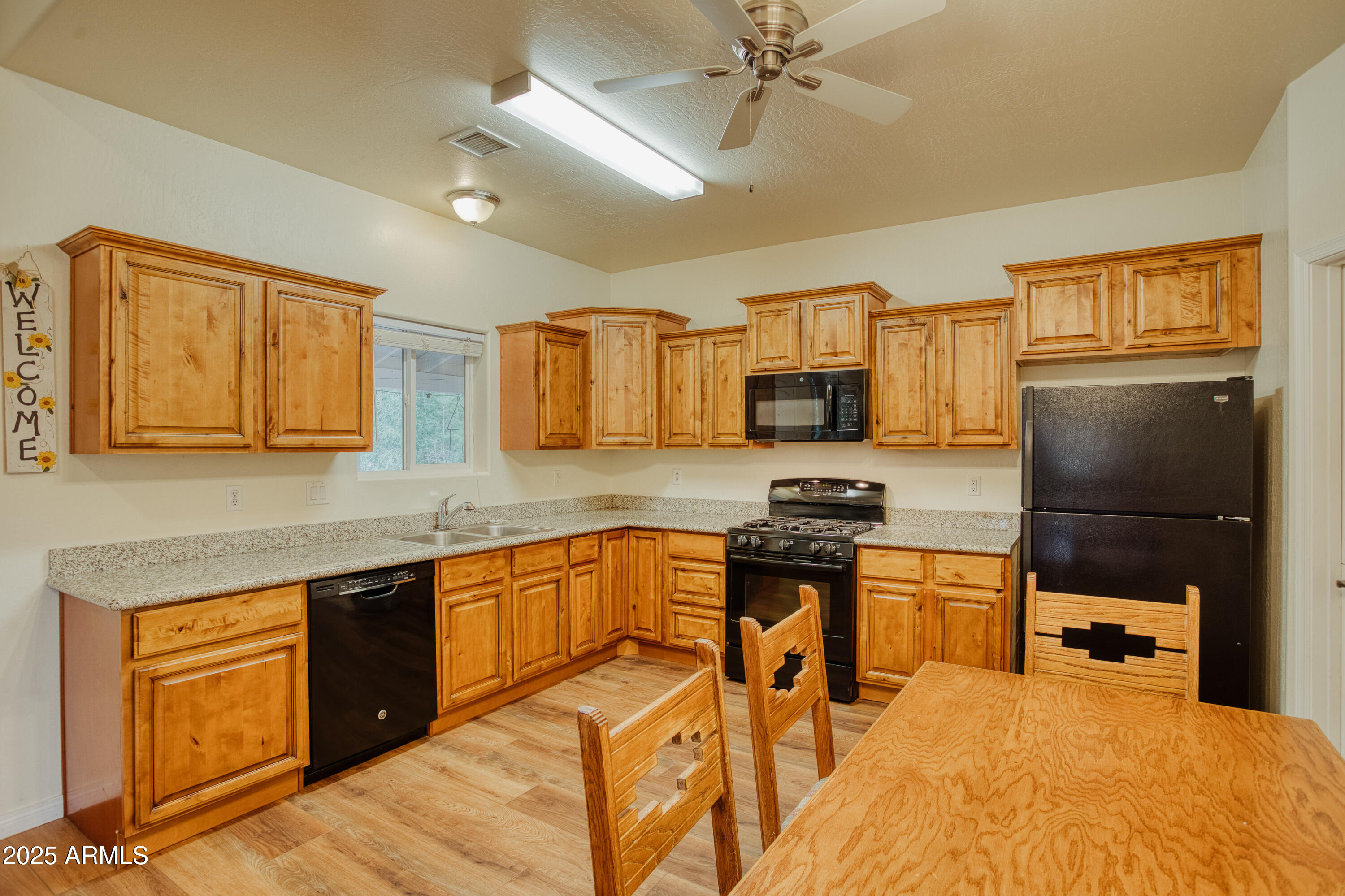 540 Rim Drive Show Low, AZ 85901 - Photo 6 of 35 a kitchen with stainless steel appliances granite countertop a stove top oven a sink dishwasher and a refrigerator