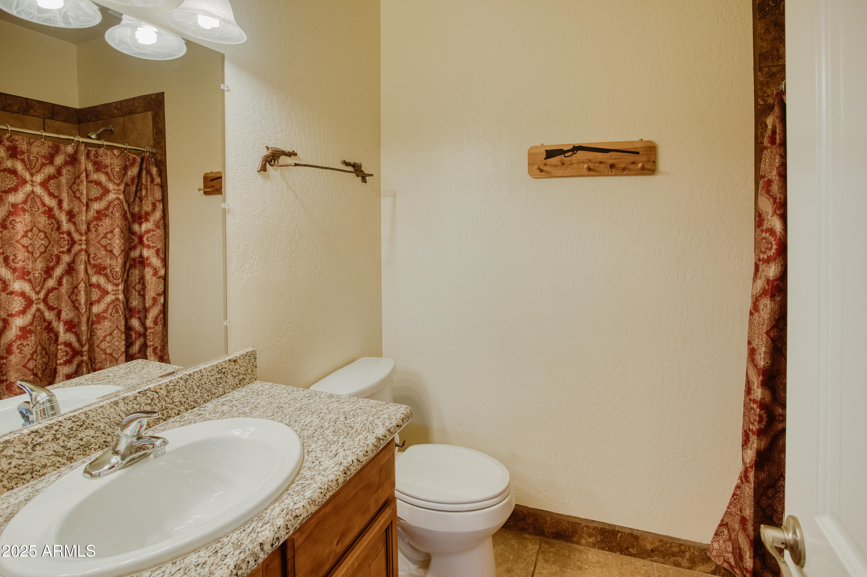 540 Rim Drive Show Low, AZ 85901 - Photo 8 of 35 a bathroom with a granite countertop sink and a mirror