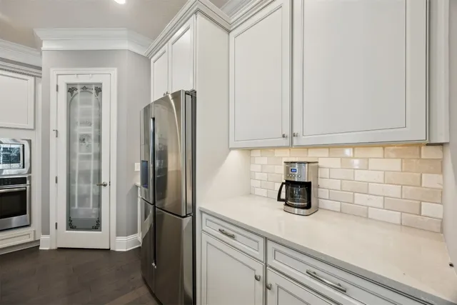 a kitchen with stainless steel appliances a refrigerator and cabinets