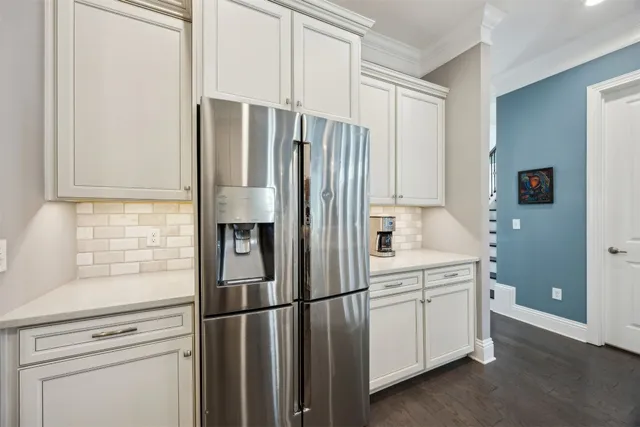 a kitchen with white cabinets and stainless steel appliances