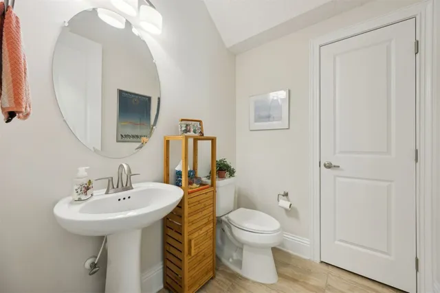 a bathroom with a toilet sink and mirror