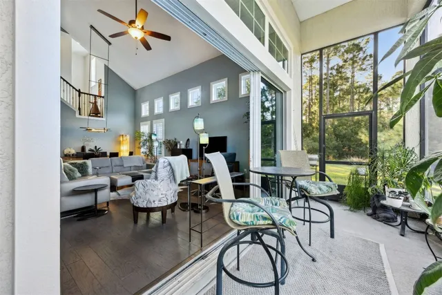a living room with furniture a rug and a chandelier