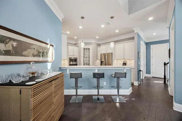 a kitchen with stainless steel appliances kitchen island granite countertop a sink and cabinets