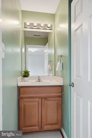 a bathroom with a granite countertop sink a mirror and a shower