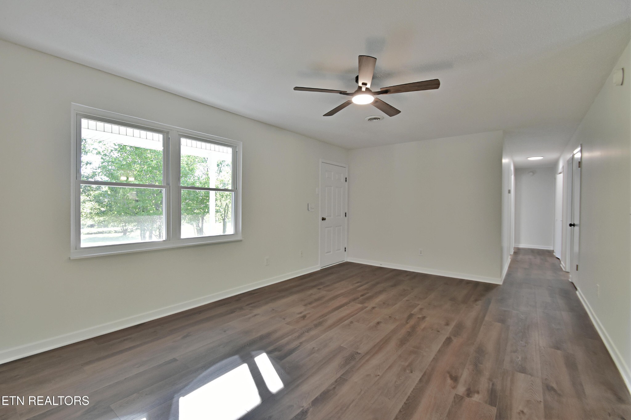 1119 Rudd Road Greenback, TN 37742 - Photo 5 of 28 a view of empty room with wooden floor and fan