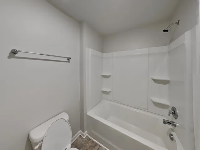 a bathroom with a toilet and a bathtub