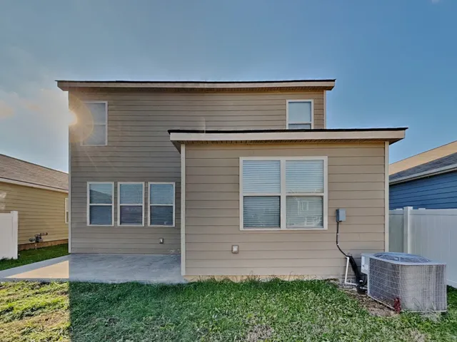 a view of house with backyard