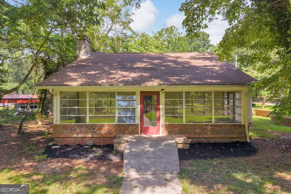a front view of a house with a yard and outdoor seating